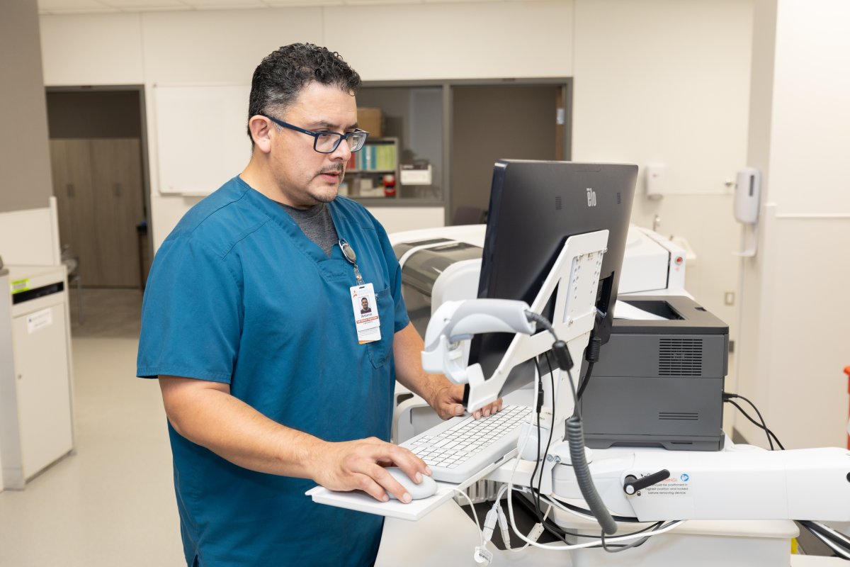 Man looks at computer in laboratory