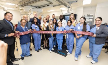 medical staff cuts ribbon at cardiac catheterization laboratory opening ceremony