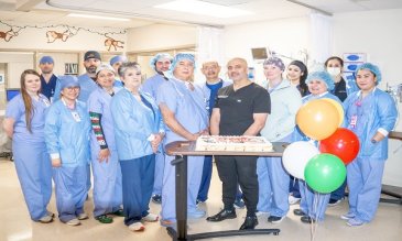 Surgical staff celebrating Dr. Saggi with cupcakes and balloons