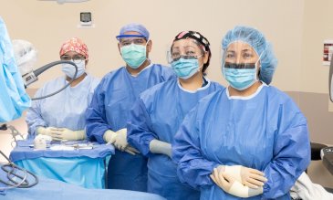 Doctors standing in operating room 