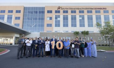 STHS Edinburg staff posing with numeric 10 balloons
