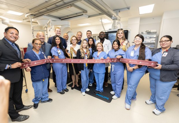 medical staff cuts ribbon at cardiac catheterization laboratory opening ceremony