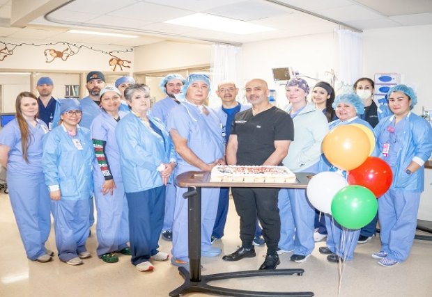 Surgical staff celebrating Dr. Saggi with cupcakes and balloons