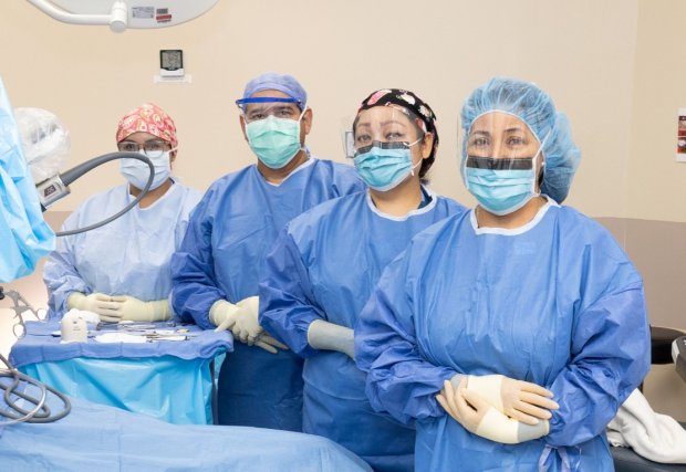 Doctors standing in operating room 