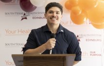 Javen Hinojosa holding a microphone